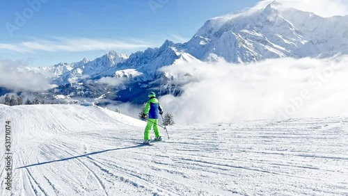 Boy ride fast on ski slope downhill over Alps Mont Blanc tops