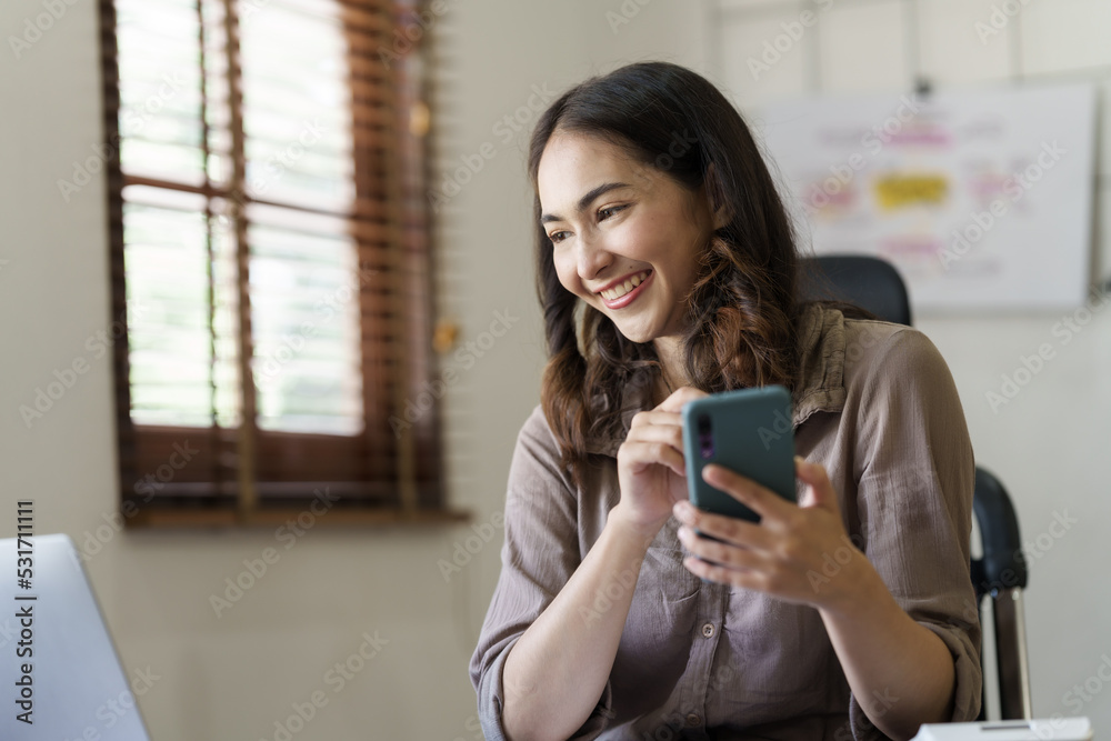 Attractive asian young woman using smartphone working office desk in office workplace. Attractive asian young woman using smartphone working office desk in office workplace.