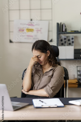 Depressed tired asian businesswoman, stressed at office workplace.