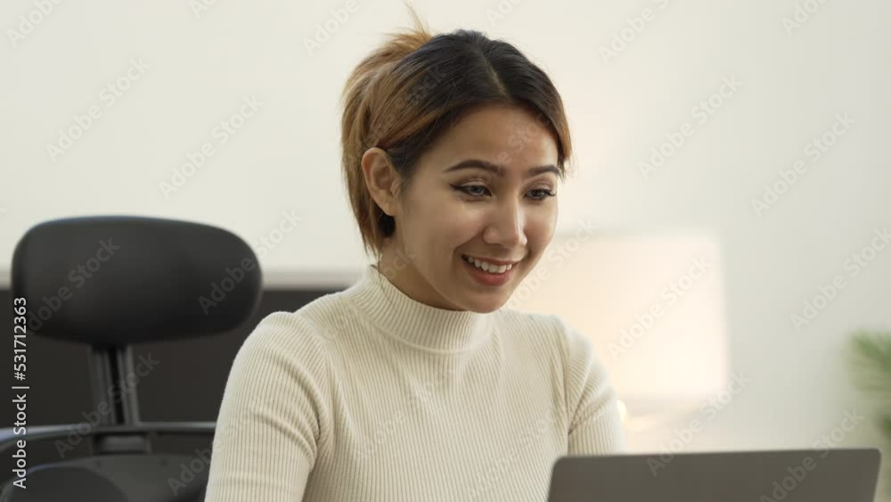 pretty asian woman working with financial statements at home office. pretty asian woman working with financial statements at home office.
