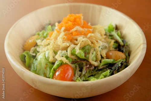Shirauo (Japanese icefish) Salad with orange fish roe on top in wooden dish.
