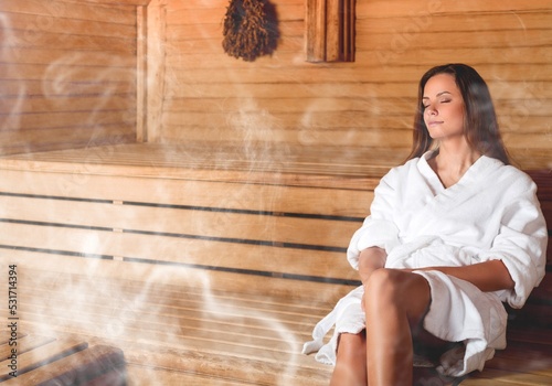 Happy woman relaxing in hot sauna with steam.