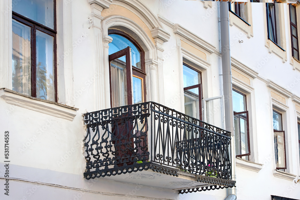 Balcony with cast iron railings and decorative elements. Cast iron