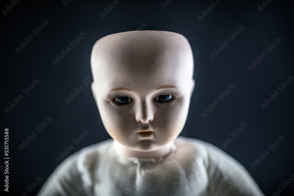 Creepy doll face on dark background Creepy doll face on dark background