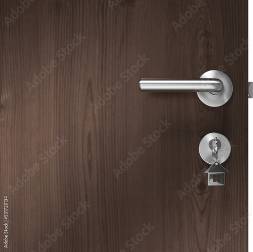 Image of key on metal house key fob inserted in door lock of wooden door