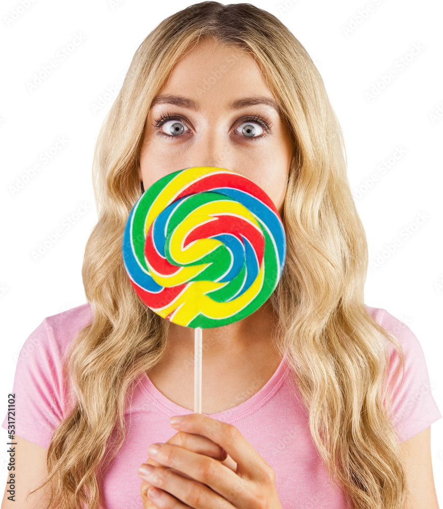 Image of caucasian blond woman holding brightly coloured lollipop with eyes wide open