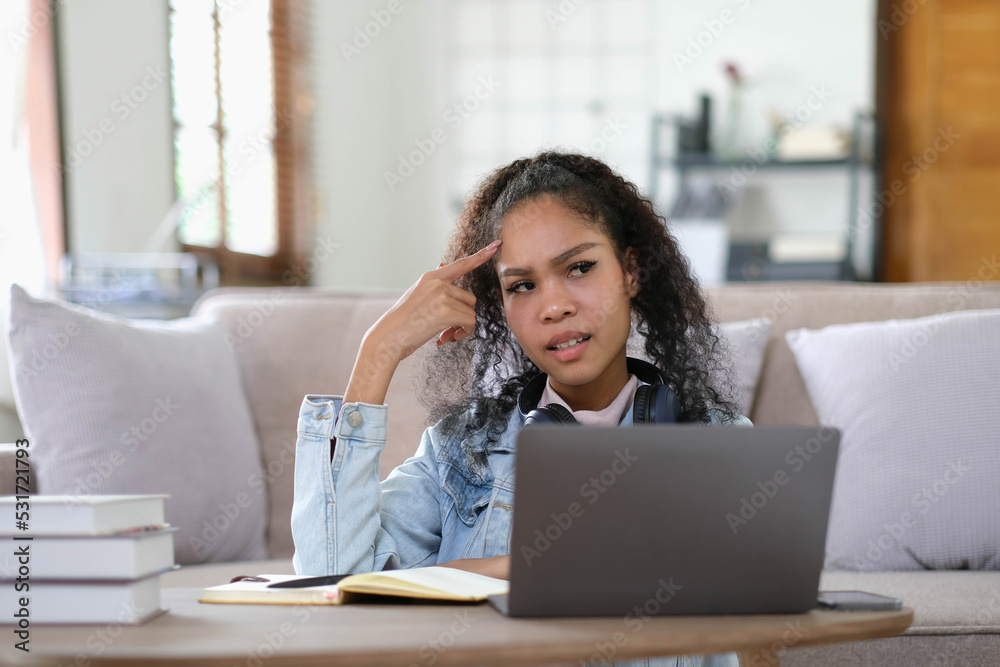Exhausted female student feeling headache from problems with university course work connected to wifi for browsing informative websites, unhappy dark skinned woman tired from e learning on laptop Exhausted female student feeling headache from problems with university course work connected to wifi for browsing informative websites, unhappy dark skinned woman tired from e learning on laptop
