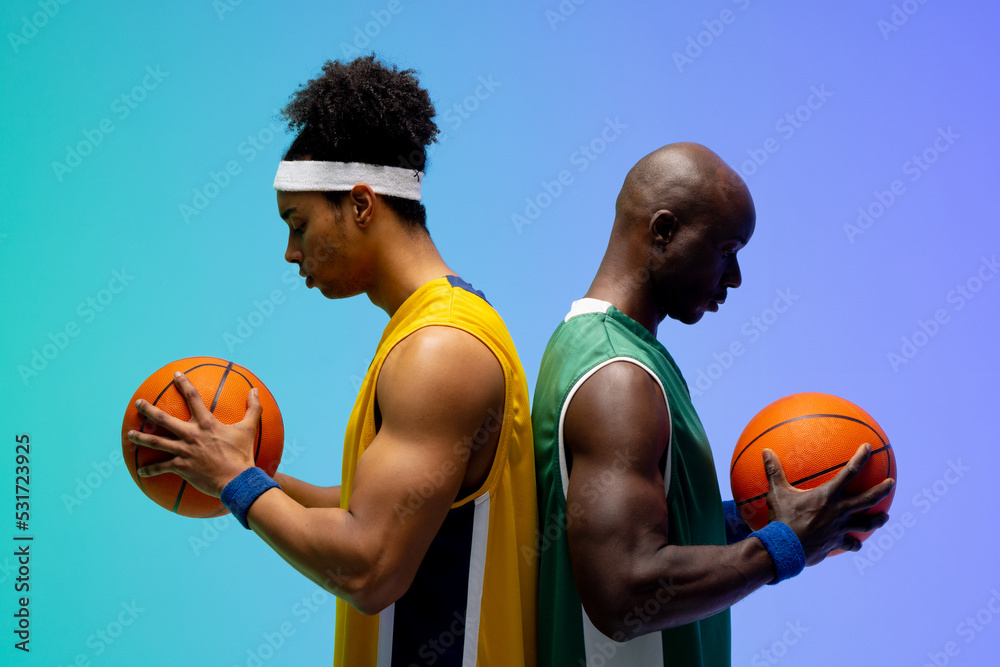 Image of two diverse basketball players with basketballs on purple to green background