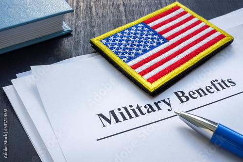 Documents about military benefits and american flag. photo