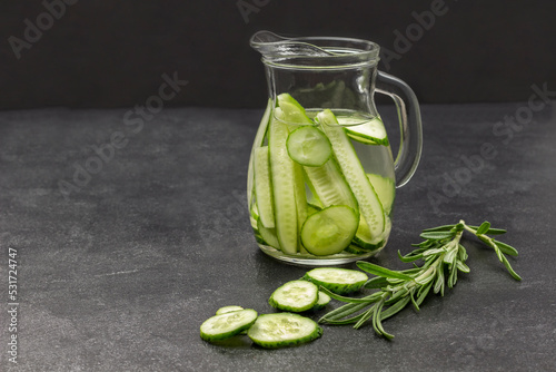 Cucumber infused water in glass jug.