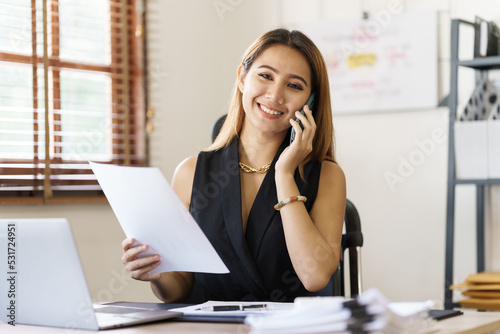Attractive asian young woman using smartphone working office desk in office workplace.