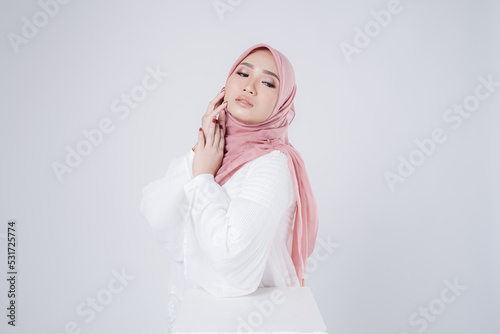Portrait of a beautiful female Muslim model wearing hijab, a lifestyle apparel for Muslim women isolated. Modern hijab fashion concept.
