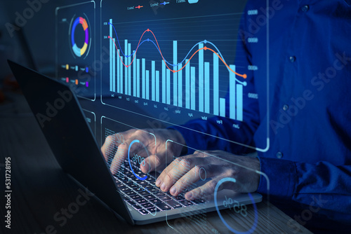 Data analyst working on business analytics dashboard with charts, metrics and KPI to analyze performance and create insight reports for operations management.