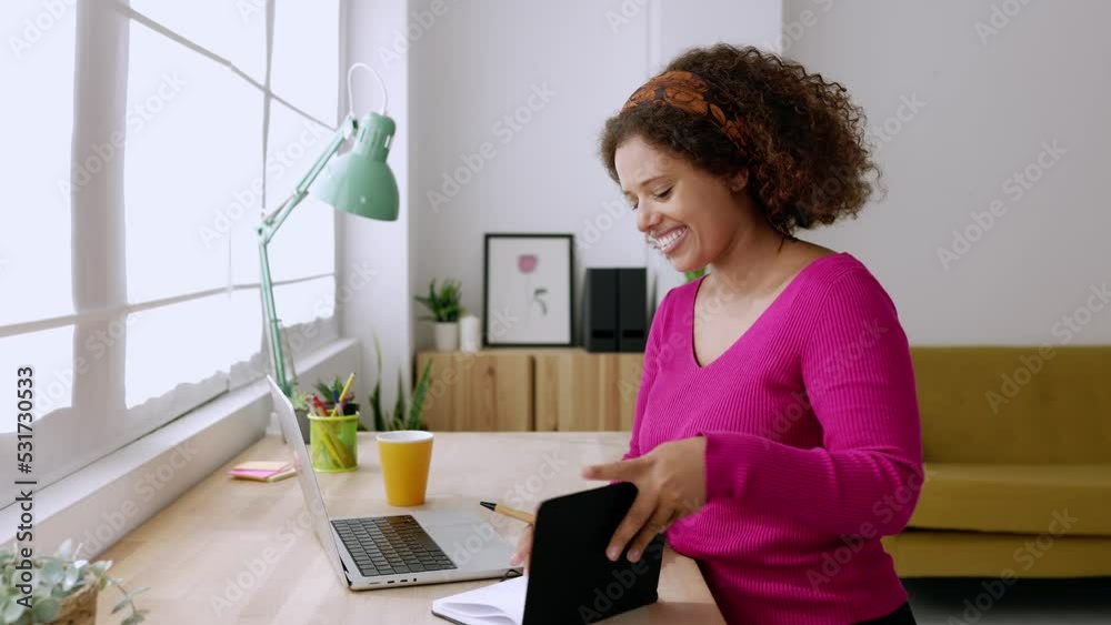 Young african woman working with laptop from home studio. Ethiopian female student taking notes while learning online at home. High quality 4k footage Young african woman working with laptop from home studio. Ethiopian female student taking notes while learning online at home. High quality 4k footage