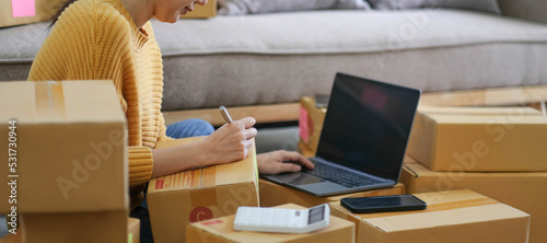 Starting small businesses SME owners female entrepreneurs check online orders to prepare to pack the boxes, sell to customers, sme business ideas online.