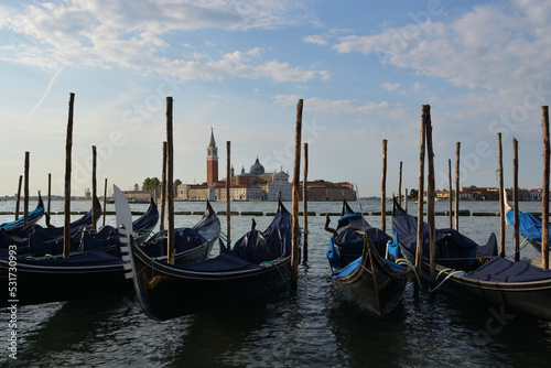 Gondolas in lagoon of Venice on sunrise, Italy © Julia