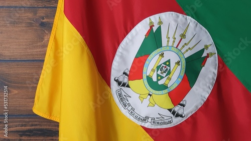 State flag of Rio Grande do Sul, Brazil, on wooden background. Gaucho day, farroupilha week.