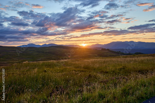 A stunning sunset over the glens and hills of Scotland