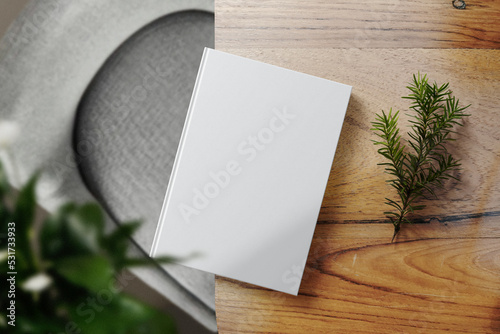 Foto Clean minimal book 4x6 mockup on top wooden table with conifer and leaves