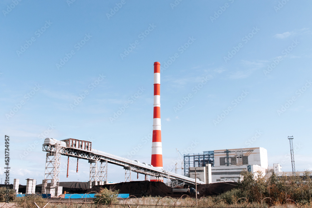 Coal-fired thermal power plant with smoke from pipes