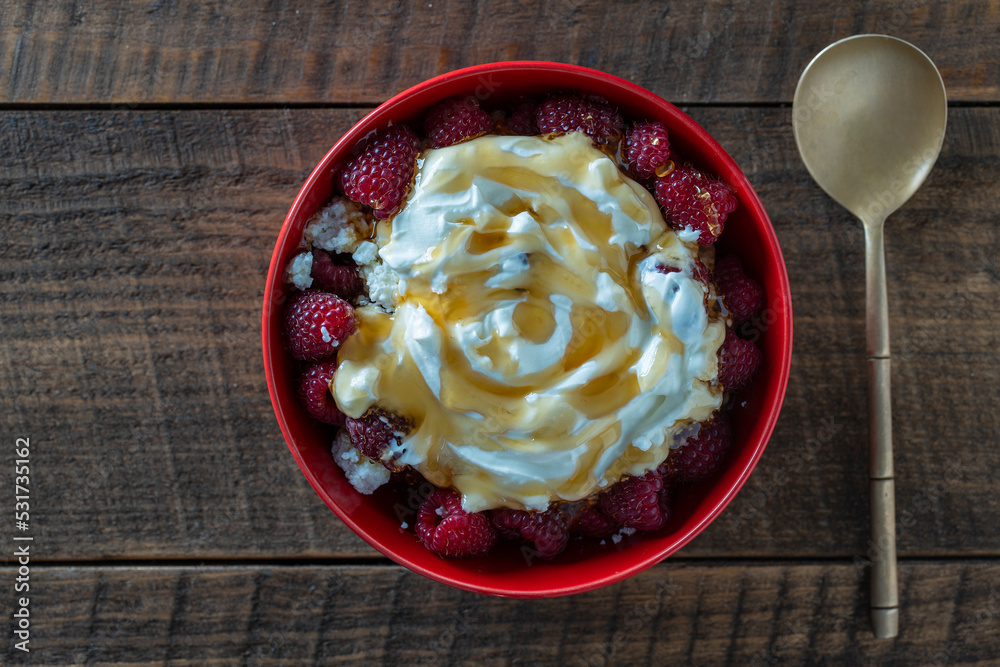 Natural organic yogurt with fresh red raspberries and cottage cheese for breakfast, top view, close up Natural organic yogurt with fresh red raspberries and cottage cheese for breakfast, top view, close up