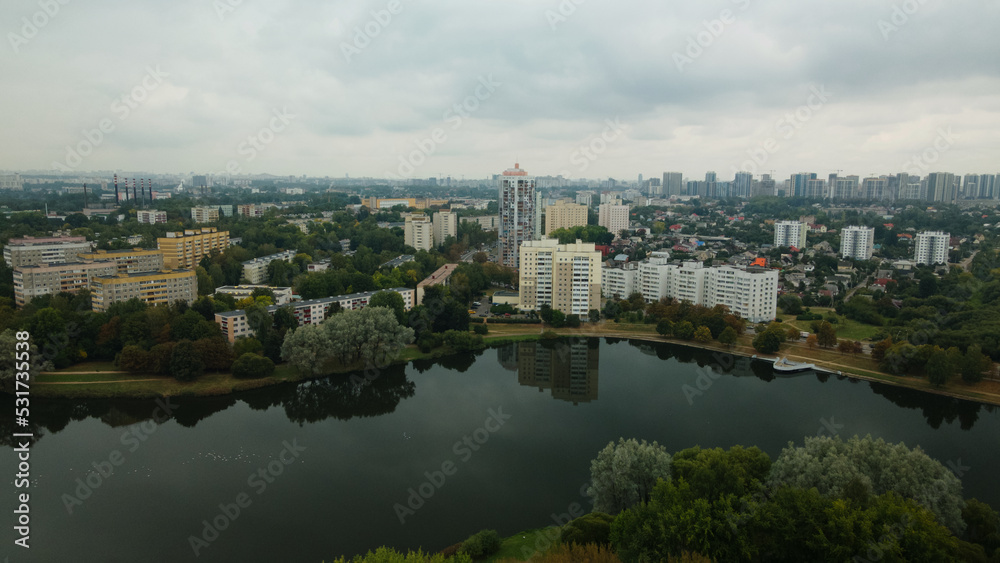 Lake in the city park. Urban landscape. Dormitory area of a big city. Aerial photography.