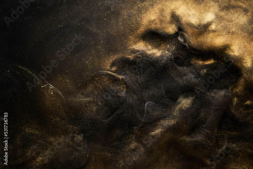 Golden sparkling abstract background, luxury black smoke, acrylic paint underwater explosion, cosmic swirling ink © amixstudio