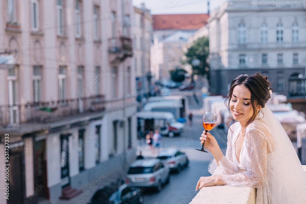 Fototapeta premium morning of the bride. A woman enjoys the view from the balcony o