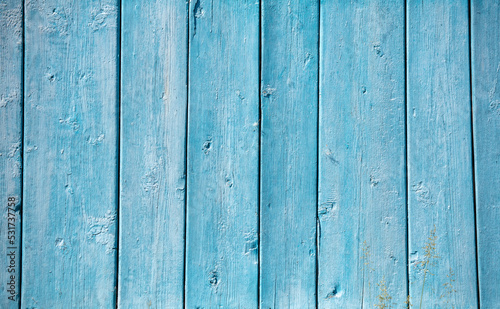 Old blue wooden boards on the fence as an abstract background.