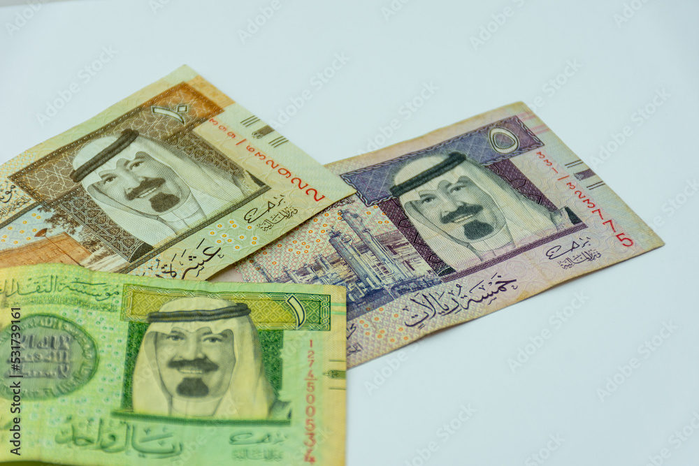 Collection of Saudi Arabia riyal banknotes on a white background. Selective focus. Collection of Saudi Arabia riyal banknotes on a white background. Selective focus.