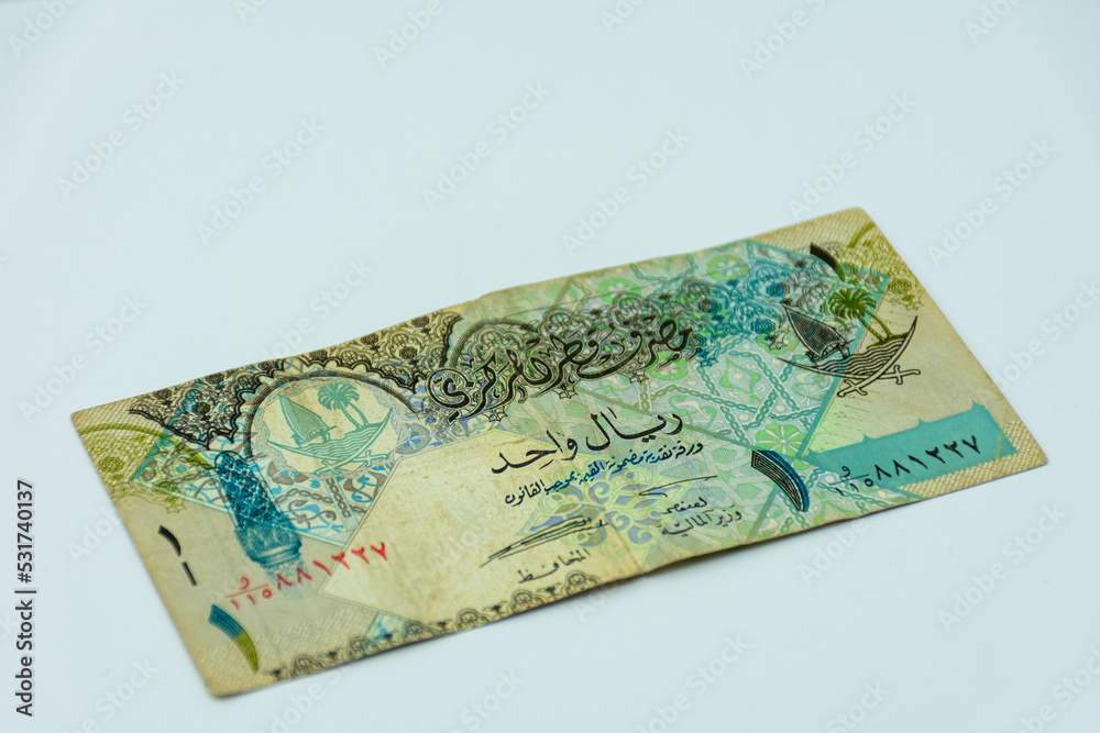Qatar riyal banknote on a white background. Selective focus. Qatar riyal banknote on a white background. Selective focus.