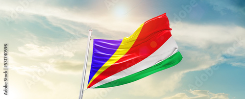 Seychelles national flag cloth fabric waving on the sky - Image