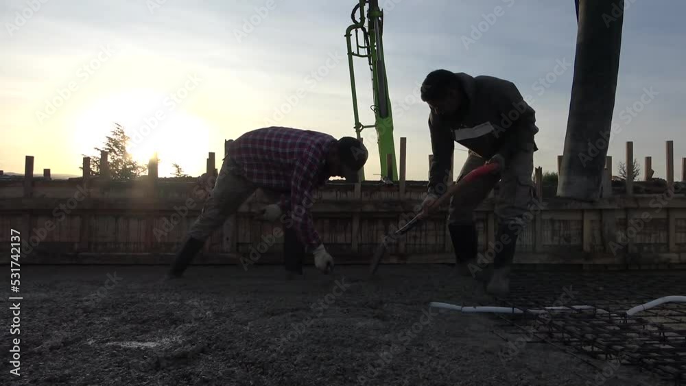 Concreting of reinforced concrete slab. Worker concretes foundation ...