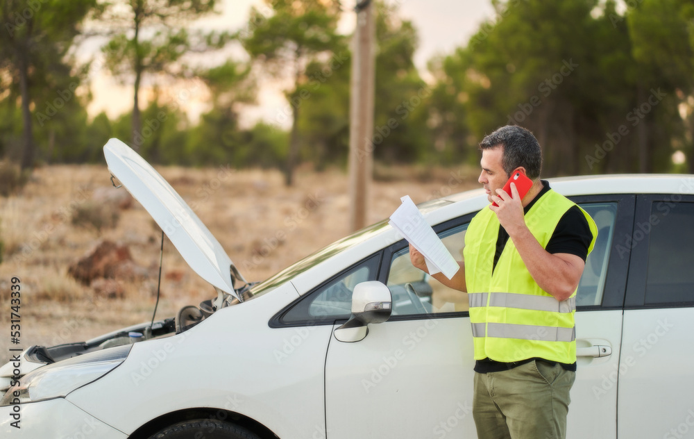 a man calling the automobile insurance company to request travel assistance for a breakdown