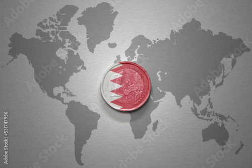 euro coin with national flag of bahrain on the gray world map background.3d illustration. photo