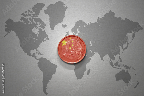 Photography euro coin with national flag of china on the gray world map background