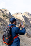 backpacker boy with smartphone in the mountains