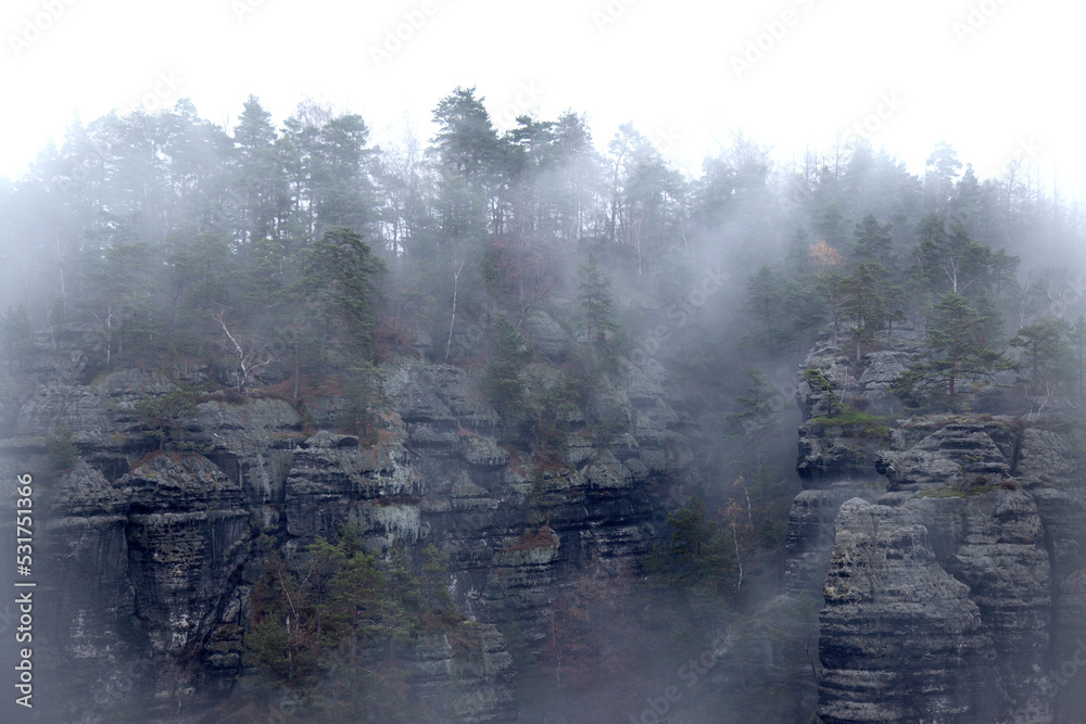 Silhouette of mountain rock on a foggy autumn day in Bohemian Switzerland National Park, Czech Republic, Czechia..