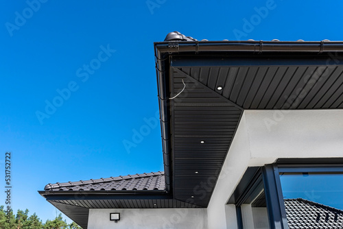 A modern graphite herringbone roof lining is attached to the trusses, visible turned on LED lights.