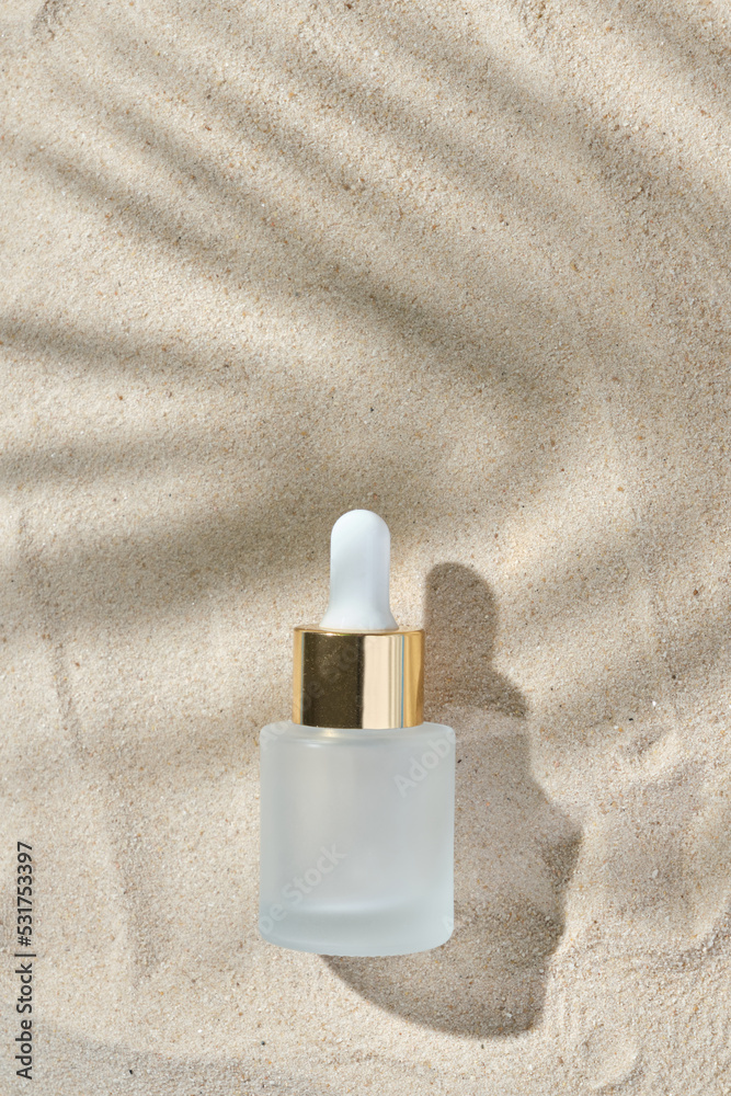 face serum of glass bottle with a pipette on a natural background with sand. Essential oil for moisturizing body skin. mockup of beauty fashion cosmetic bottle dropper product with skincare concept. face serum of glass bottle with a pipette on a natural background with sand. Essential oil for moisturizing body skin. mockup of beauty fashion cosmetic bottle dropper product with skincare concept.