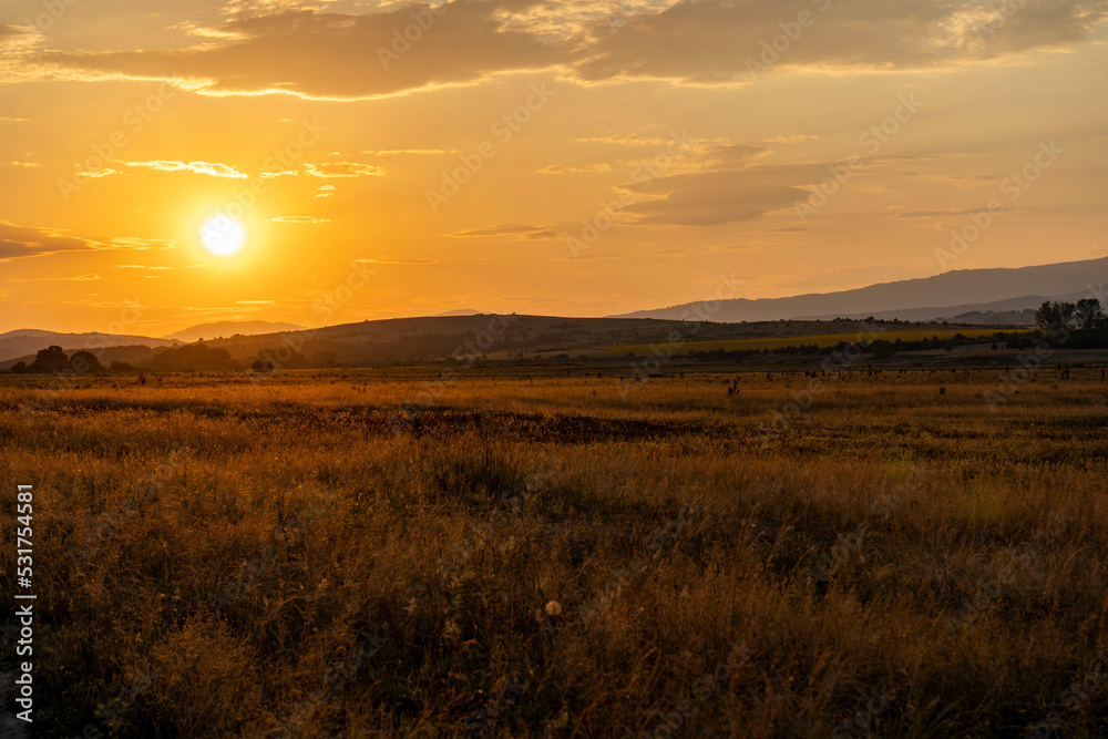 Golden sunset over the fields around the dam