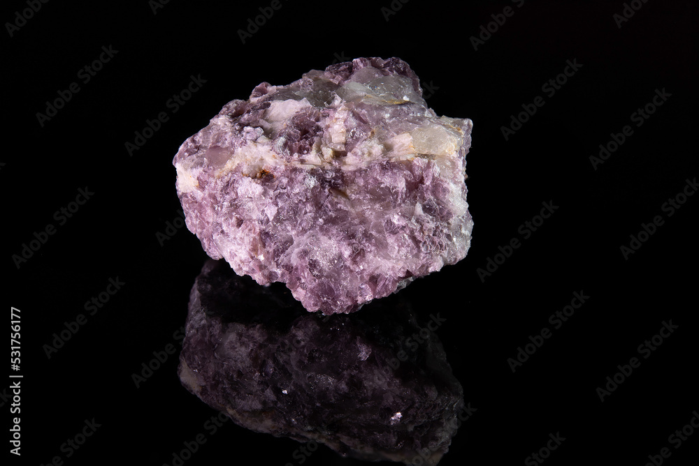A fragment of the mineral lepidolite with a rough crystalline surface of a pinkish color A fragment of the mineral lepidolite with a rough crystalline surface of a pinkish color