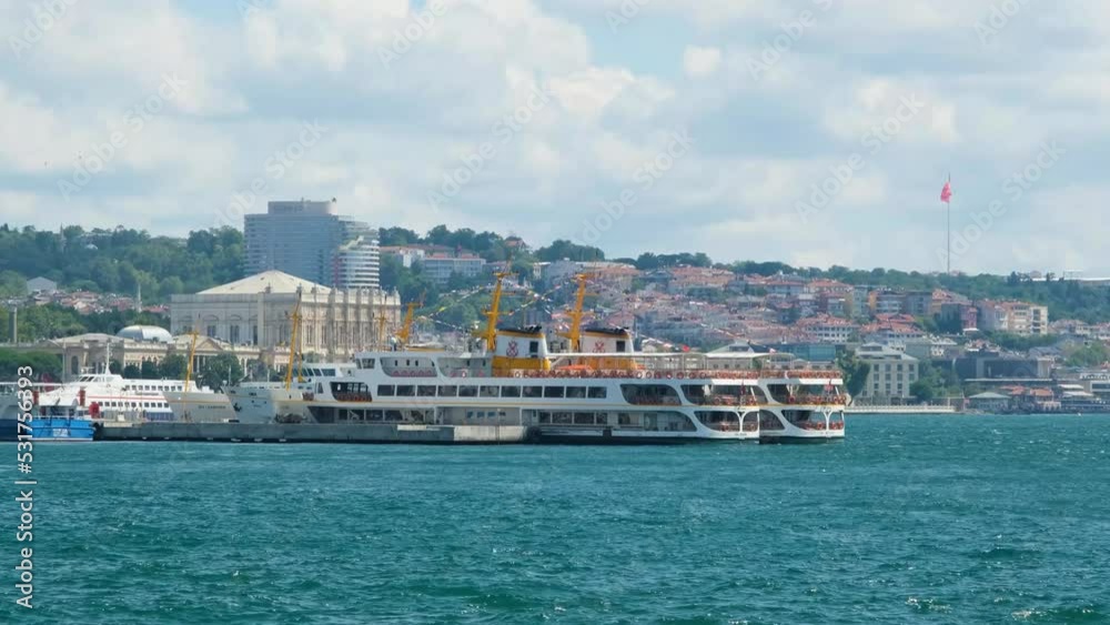 Ferryboat on port with Turkish flag in background, tourism concept, travel and transport idea, blue sea and cloudy sky, 4k 60 fps video in Istanbul Ferryboat on port with Turkish flag in background, tourism concept, travel and transport idea, blue sea and cloudy sky, 4k 60 fps video in Istanbul