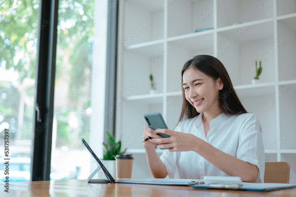 Young beautiful woman is texting and chatting with friends on smartphone at home. Young beautiful woman is texting and chatting with friends on smartphone at home.