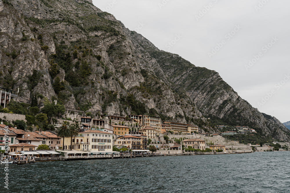 Picturesque view of old touristic town near mountains and lake. Scenic seaside nature landscape. Summer vacation travel concept