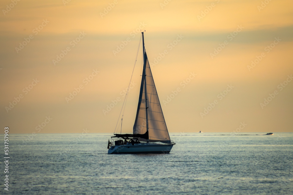 Sunset at Grand Bend Ontario as Boats Passes by