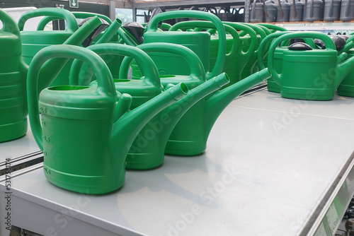Ordinary watering cans on sale in the store, green color