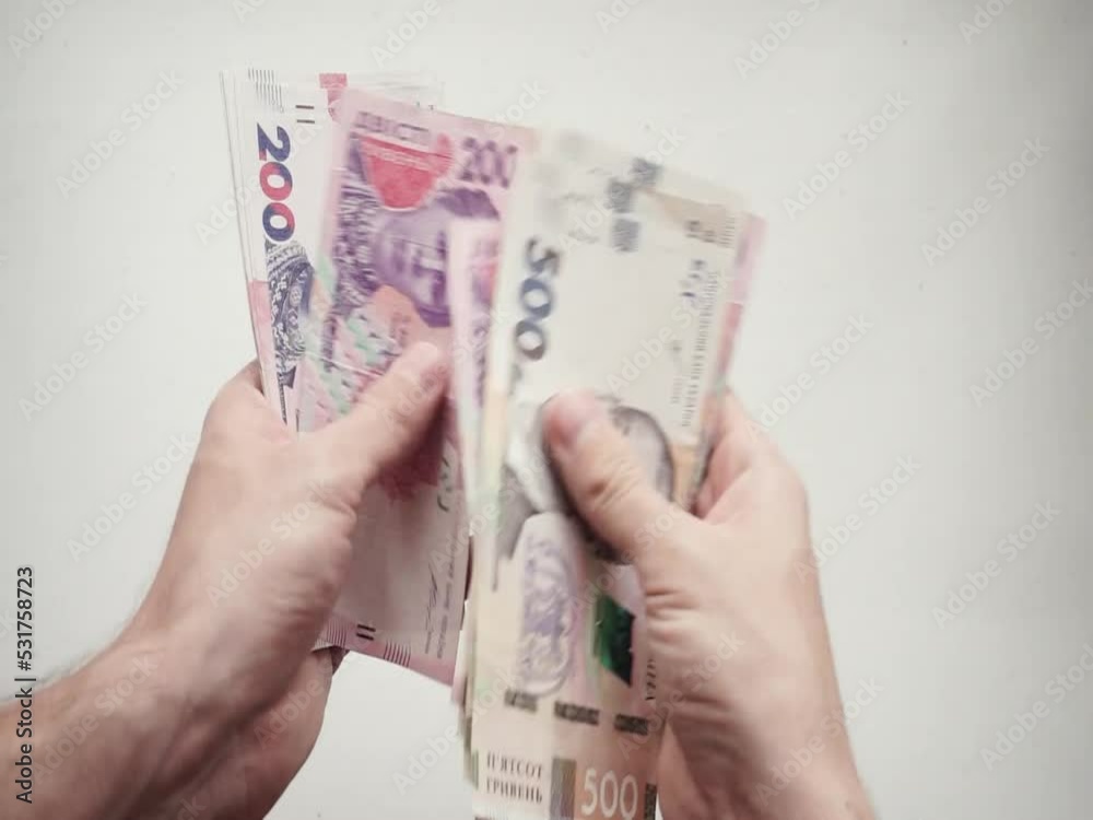 Account of Ukrainian paper banknotes of different denominations in the hands of a person Account of Ukrainian paper banknotes of different denominations in the hands of a person