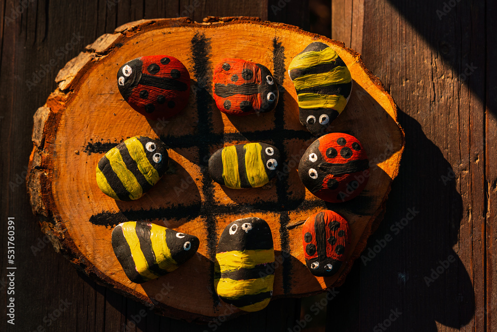Hand made wood burn tic tac toe game with painted rock game pieces