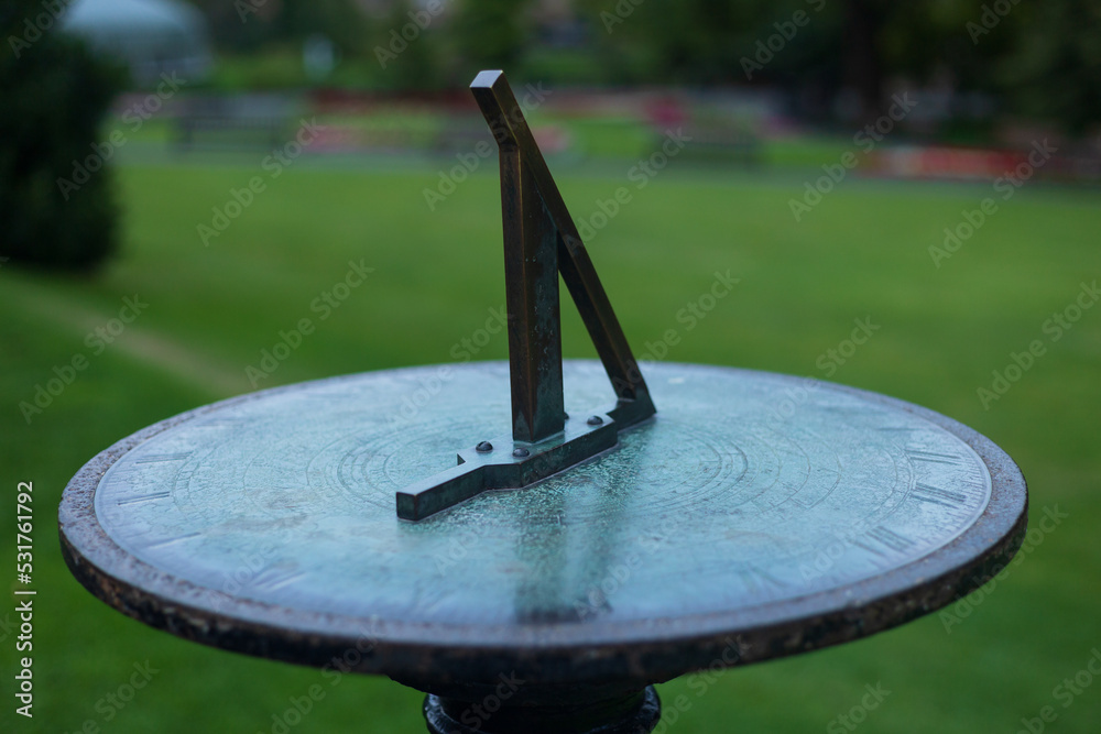 A sundial in a garden on a autumnal morning